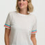 Woman wearing a white t-shirt with colorful sleeves against a plain background