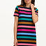 A model wearing a black and multicolored striped t-shirt dress with short sleeves.