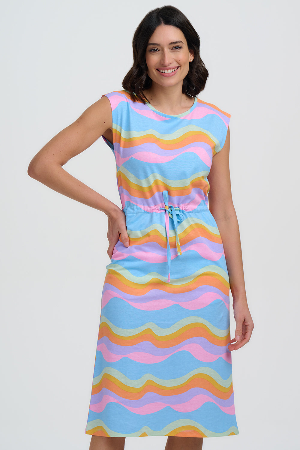Woman wearing a colorful sleeveless dress with a white background