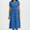Woman wearing a blue dress with a pattern on a white background
