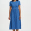 Woman wearing a blue dress with a pattern on a white background