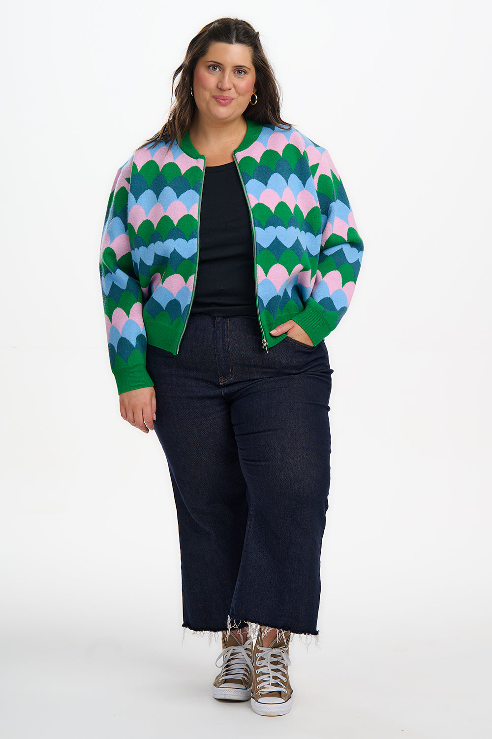Person wearing a colorful patterned jacket on a white background