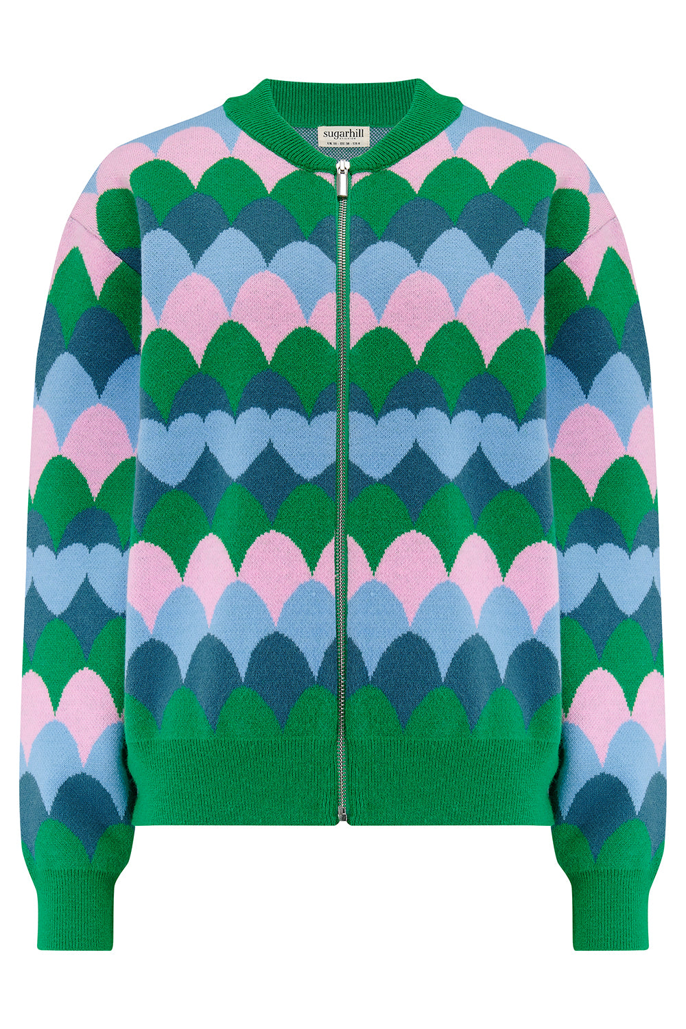 A model wearing a multicoloured knitted bomber jacket with a heart scallop pattern in green, blue, and pink.