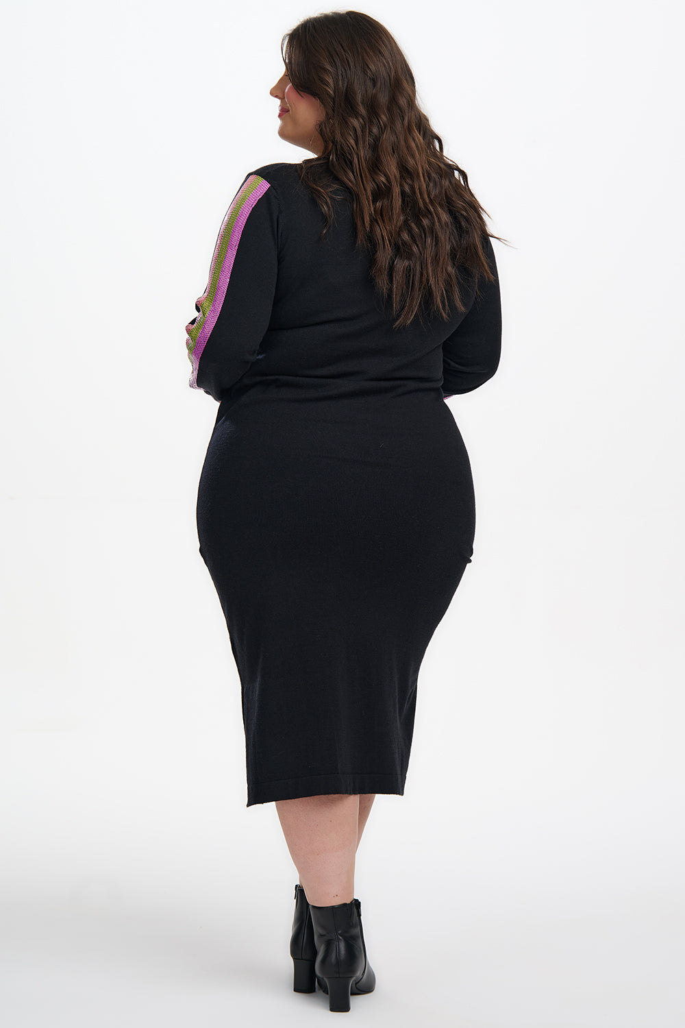 Person wearing a black dress with a pink stripe on a white background