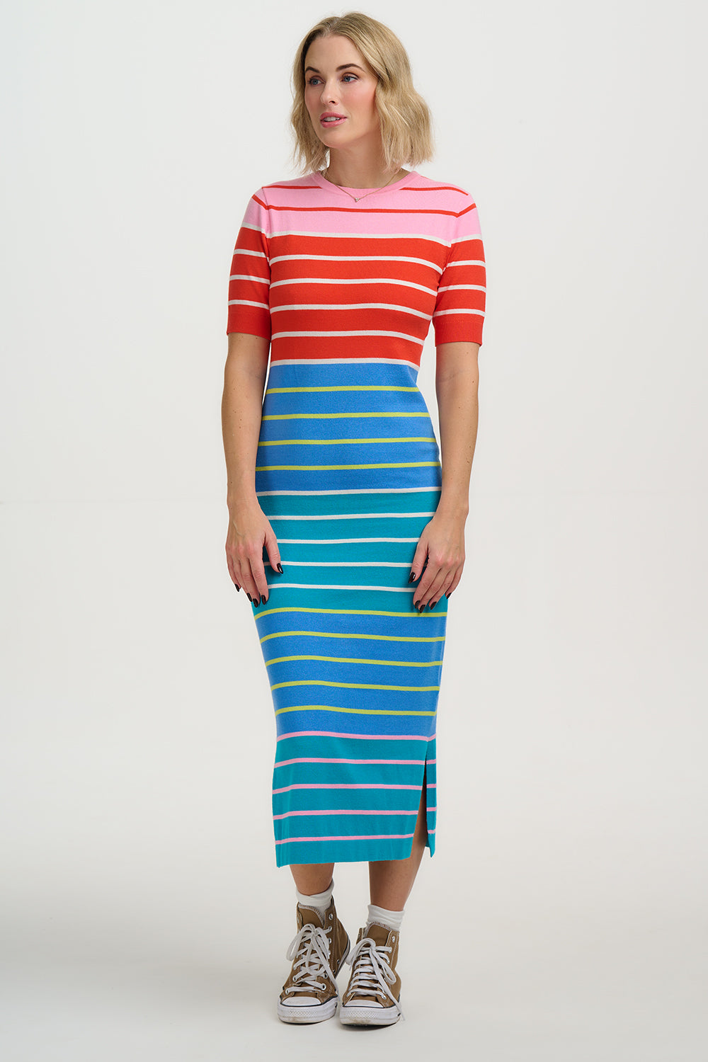 Person wearing a red and white striped top with a blue and yellow striped skirt on a white background