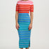 Person wearing a red and white striped top with a blue and yellow striped skirt on a white background