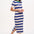 A model wearing a short-sleeved blue and white striped midi knit dress with a contrasting green neckline.