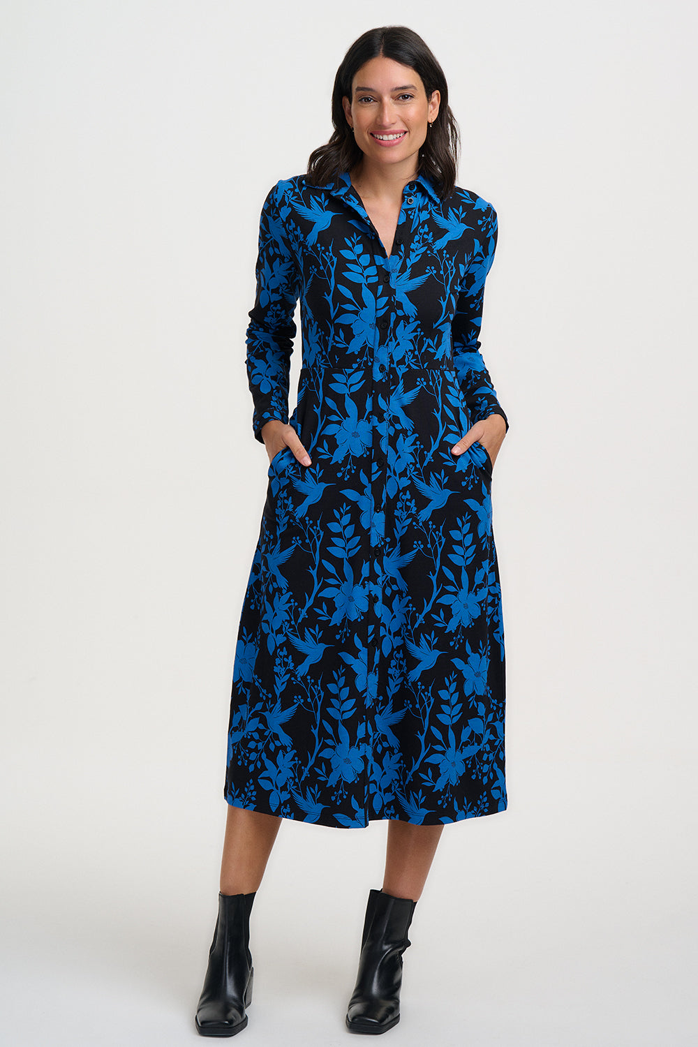 Woman wearing a blue patterned dress on a white background