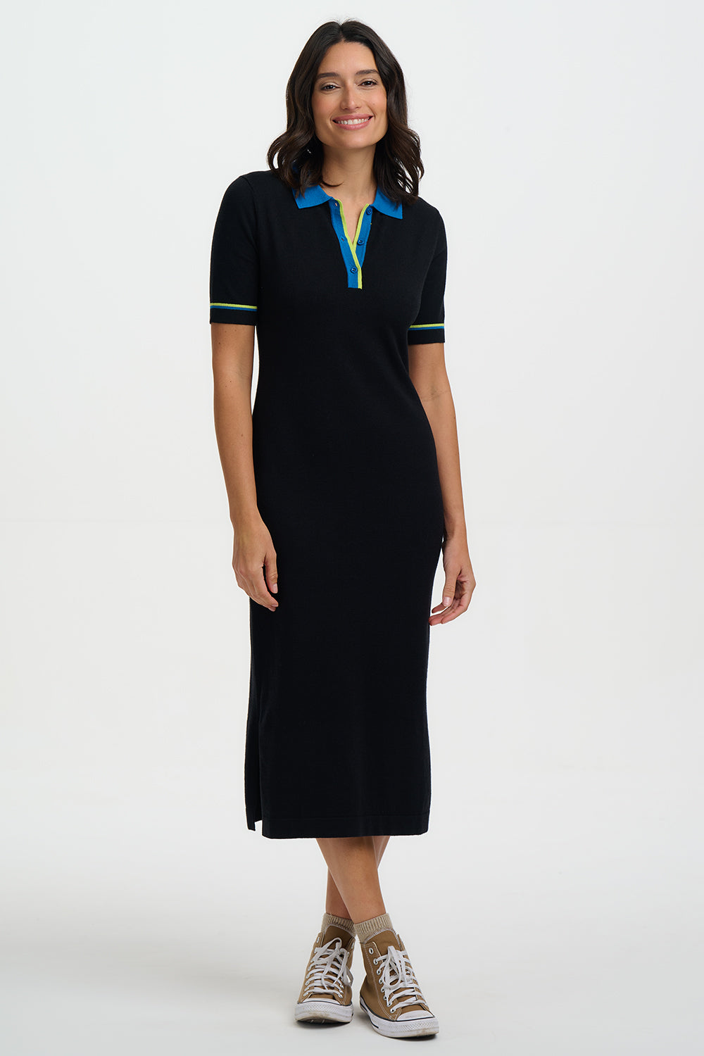 Woman wearing a black dress with blue and yellow accents on a white background