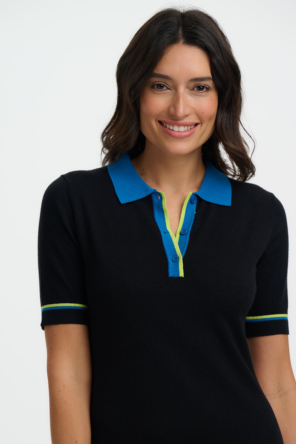 Woman wearing a black polo shirt with blue collar and trim on a white background