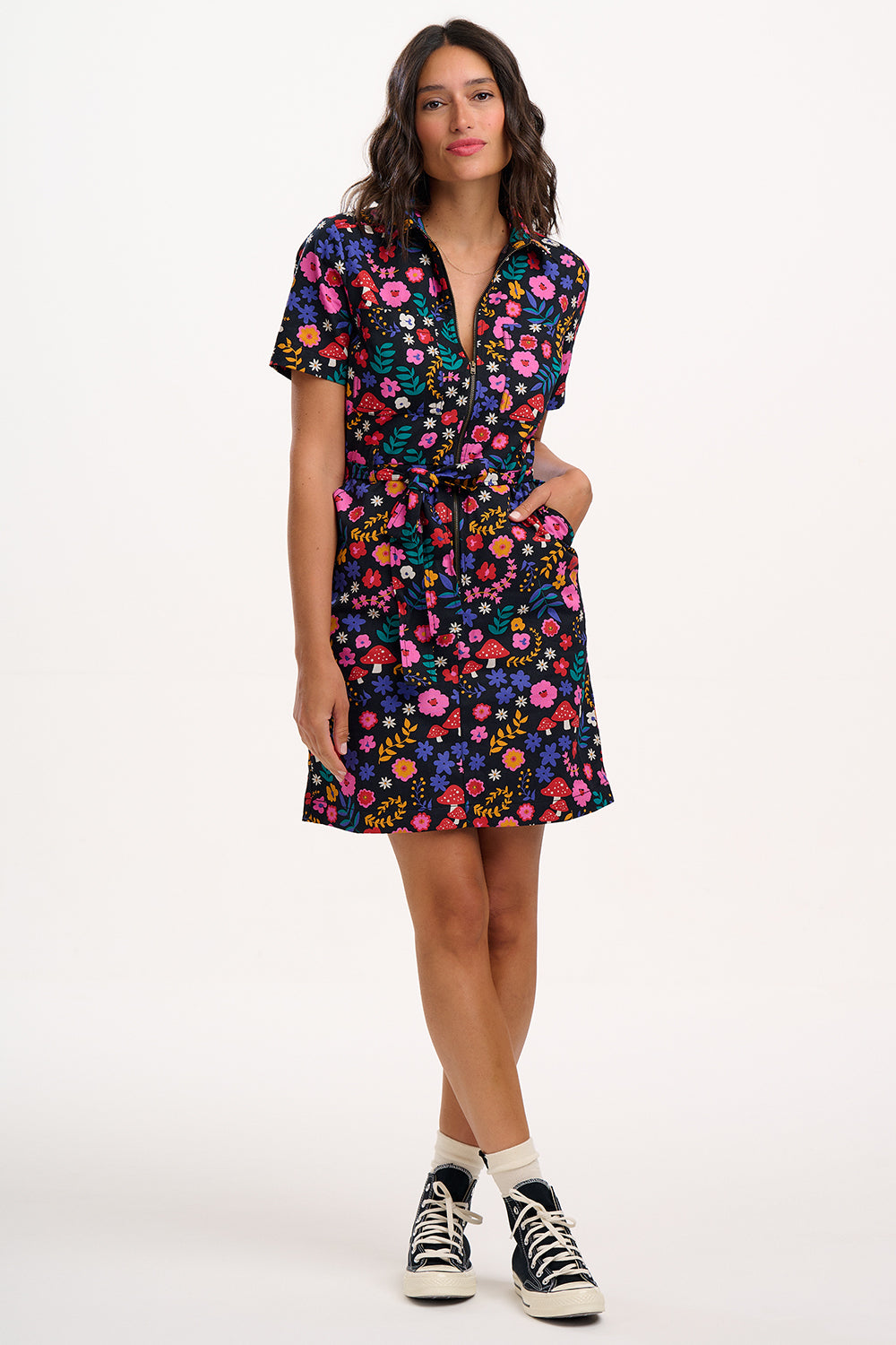 Woman wearing a colorful floral dress on a white background