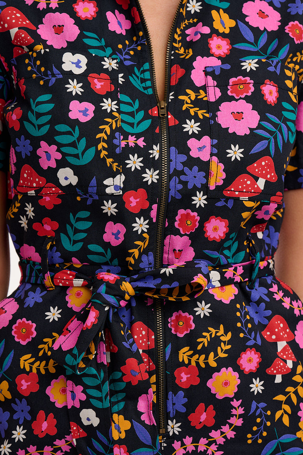 Colorful floral-patterned outfit with a zipper on a black background