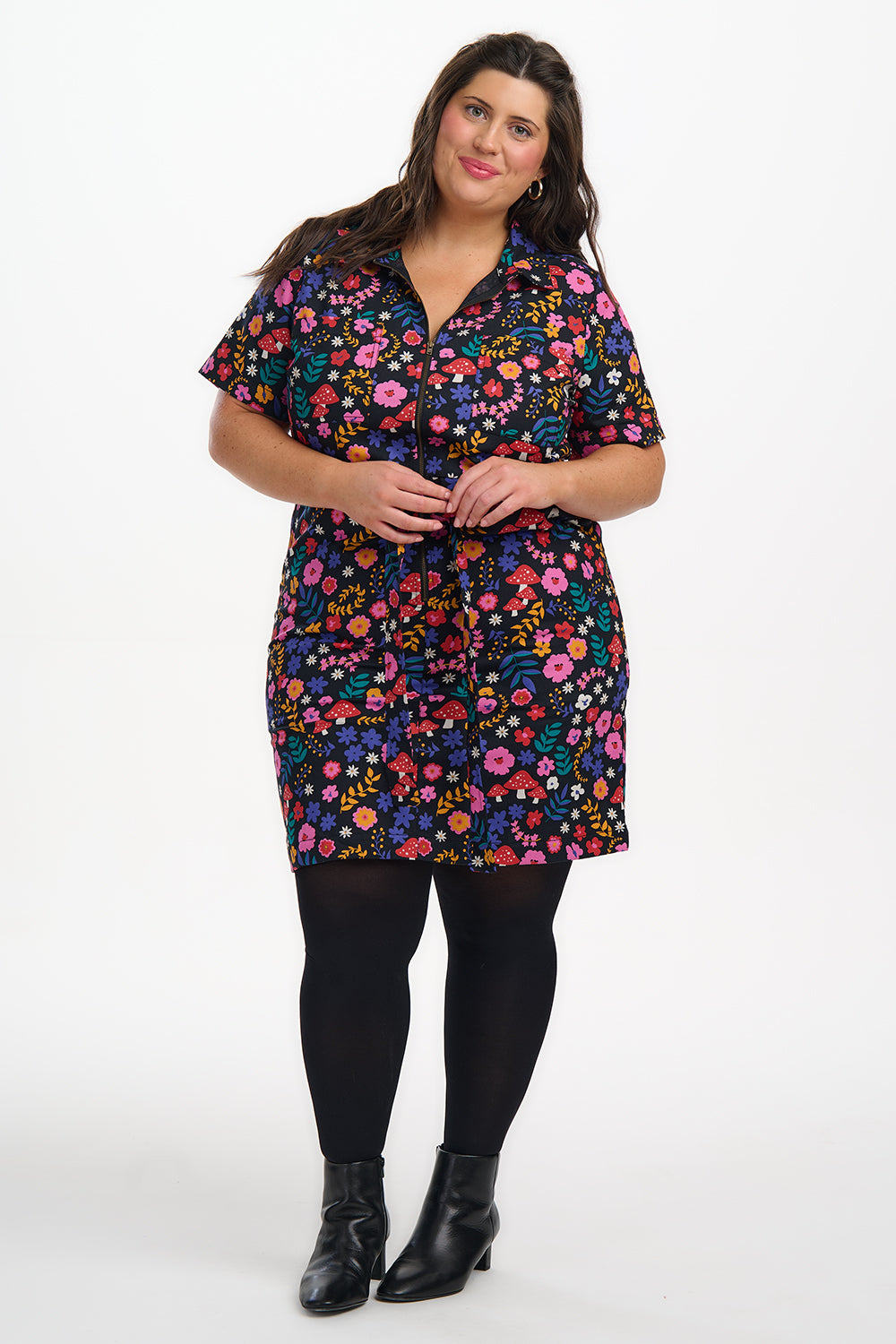 Woman wearing a colorful floral dress on a white background
