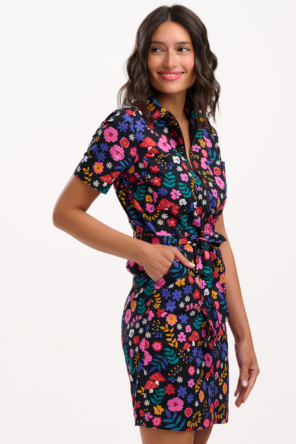 Woman wearing a colorful floral dress on a white background