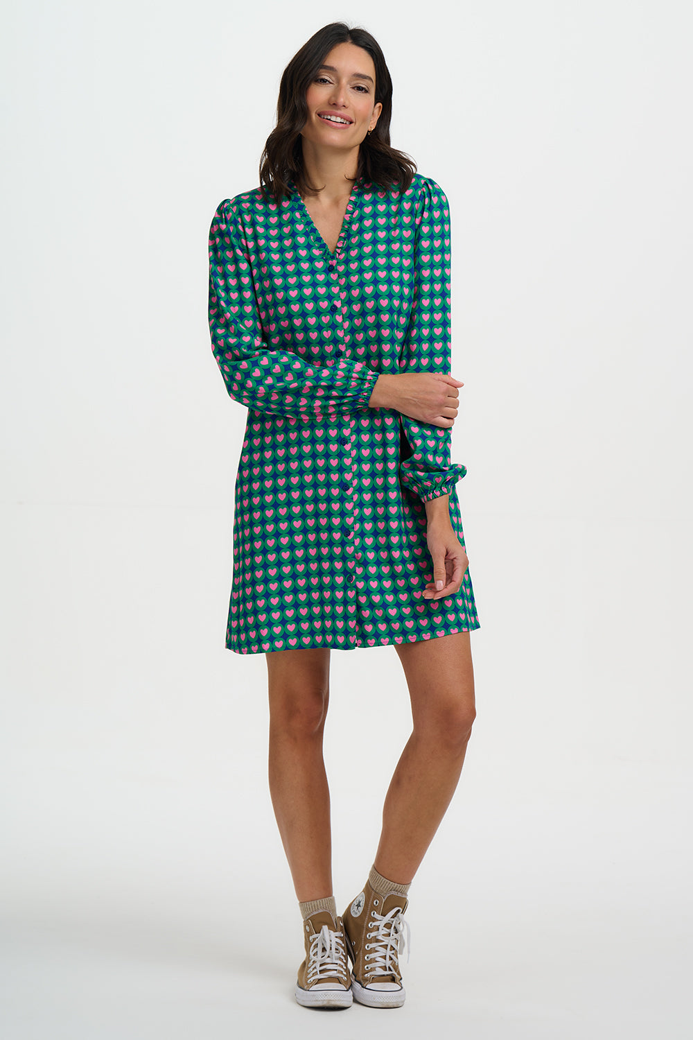 Woman wearing a green checkered dress on a white background