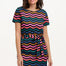 A model wearing a short-sleeved mini dress with a wavy chevron stripe pattern in black, teal, navy, tan, pink, and coral colors.