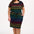 A model wearing a short-sleeved black mini dress with a colorful striped pattern and pockets