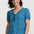 Woman wearing a blue and green checkered blouse against a white background