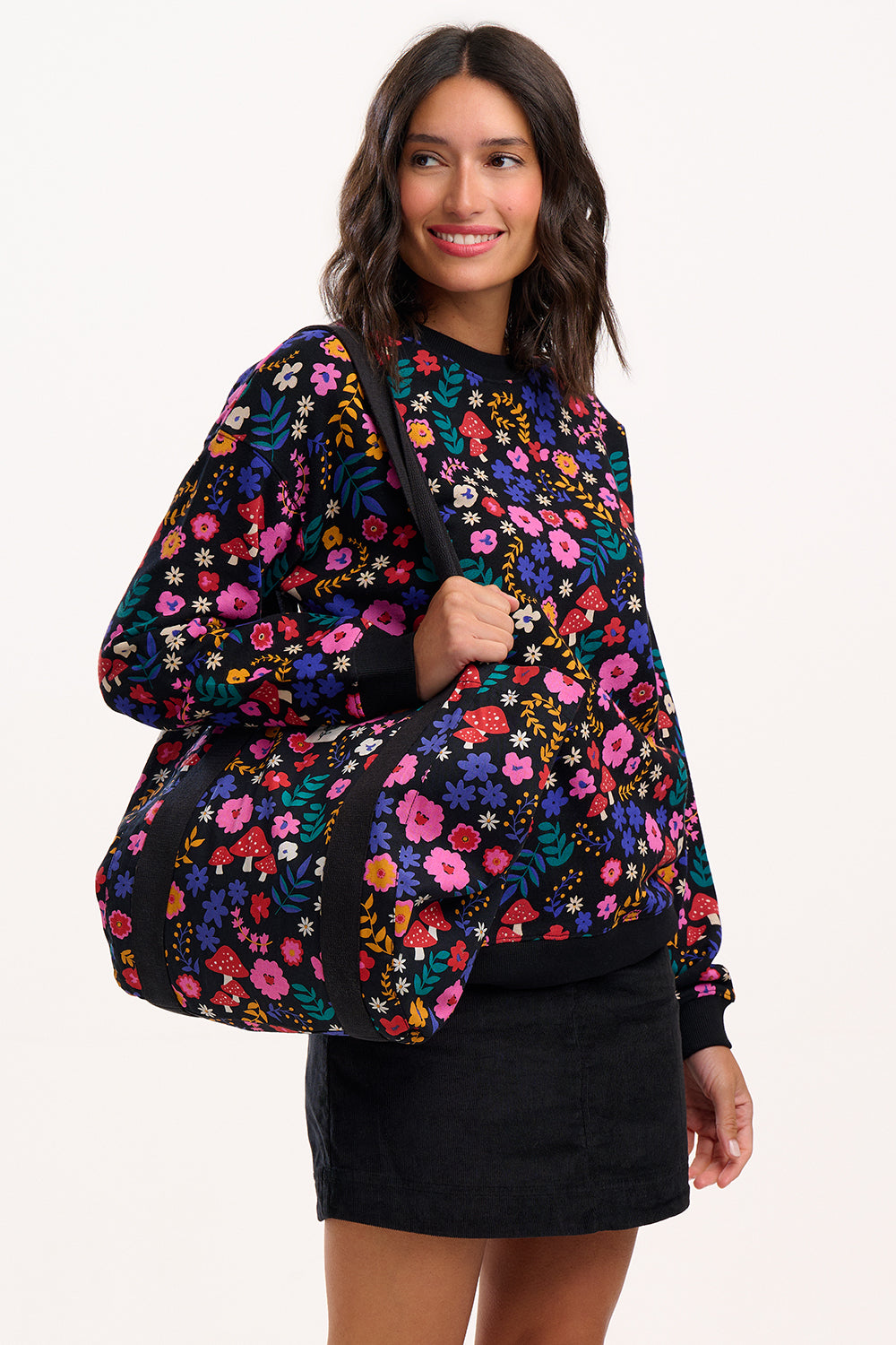 Woman wearing a colorful floral-patterned jacket on a white background