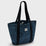 Blue tote bag with black straps on a light gray background