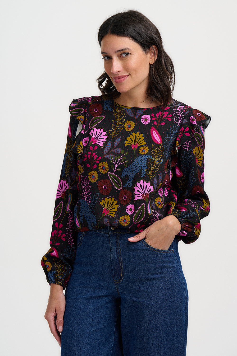 Woman wearing a floral blouse with long sleeves on a white background