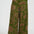 Green patterned pants worn by a person on a white background