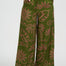 Green patterned pants worn by a person on a white background