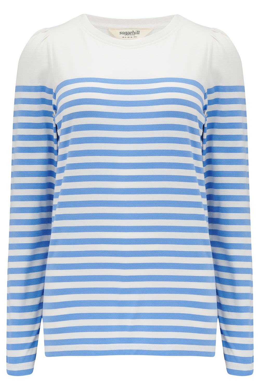 A woman wearing an off-white jersey top with horizontal French blue and off-white stripes, paired with blue jeans.