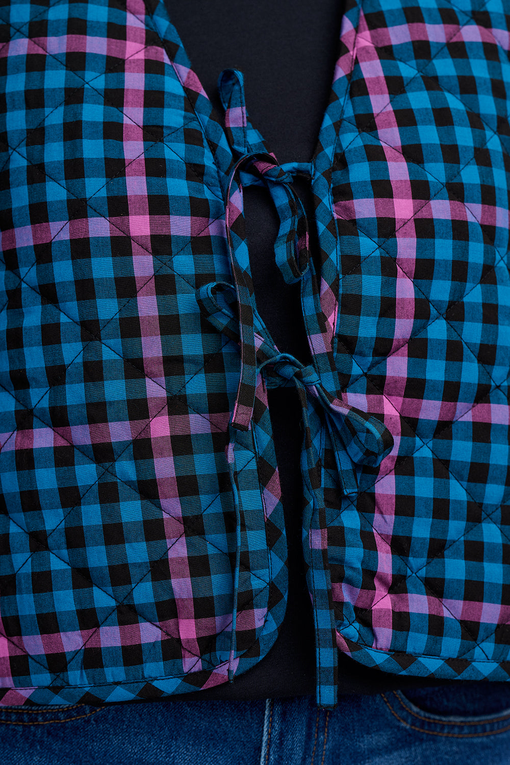 Close-up of a blue and pink checkered fabric with a dark background
