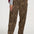Person wearing leopard print pants and white sneakers on a white background