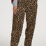 Person wearing leopard print pants and white sneakers on a white background