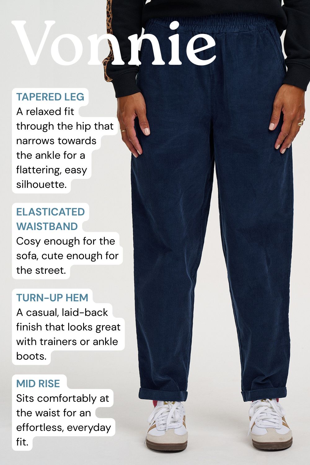 A person wearing dark navy tapered pants with a white text overlay detailing the fit and features of the Vonnie pants, set against a plain light gray background.