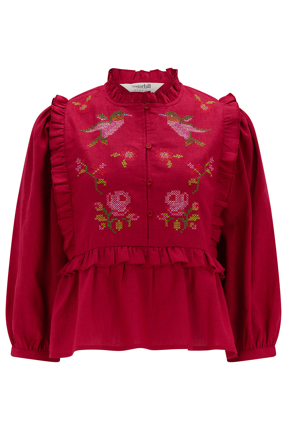 Red blouse with floral embroidery on a white background