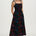 Woman wearing a black floral dress on a white background