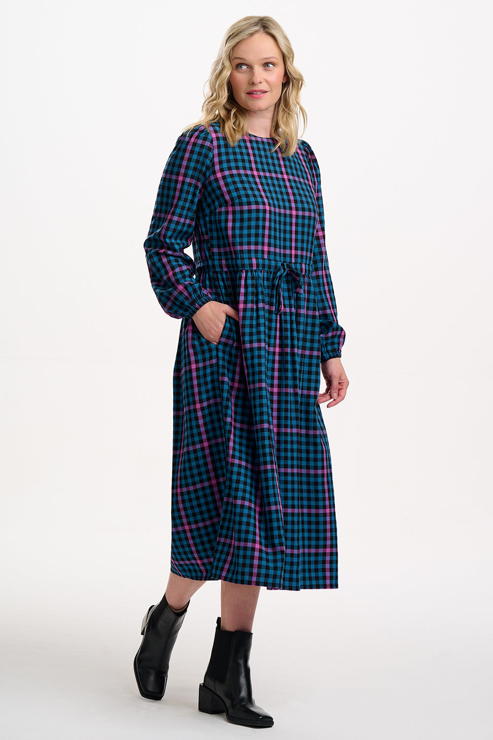 Sugarhill Brighton model wearing a blue and pink plaid dress on a white background
