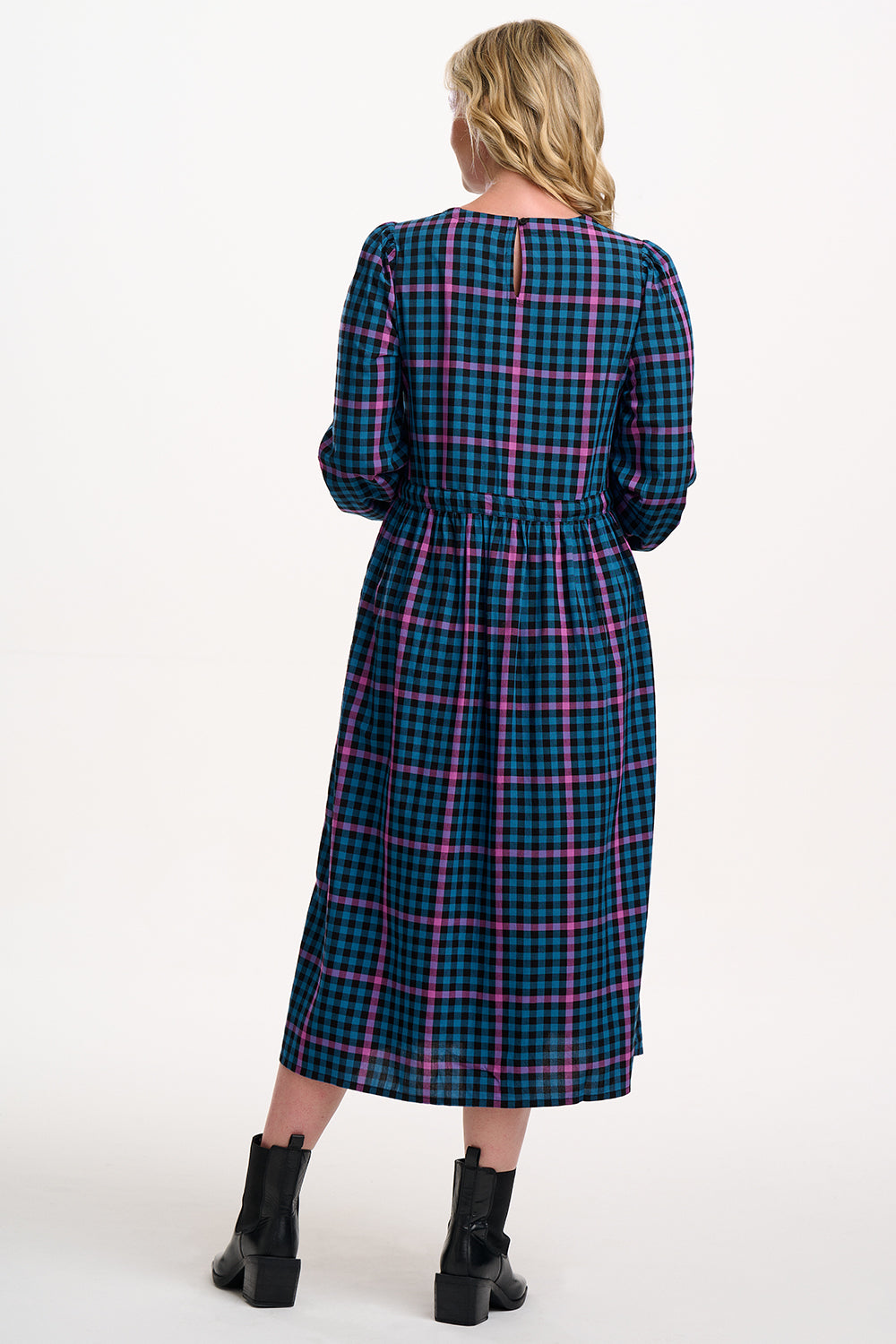 Sugarhill Brighton model wearing a plaid dress with a white background