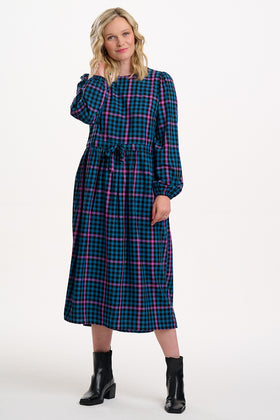 Sugarhill Brighton model wearing a plaid dress with long sleeves on a white background