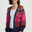 Woman wearing a colorful patterned cardigan on a white background