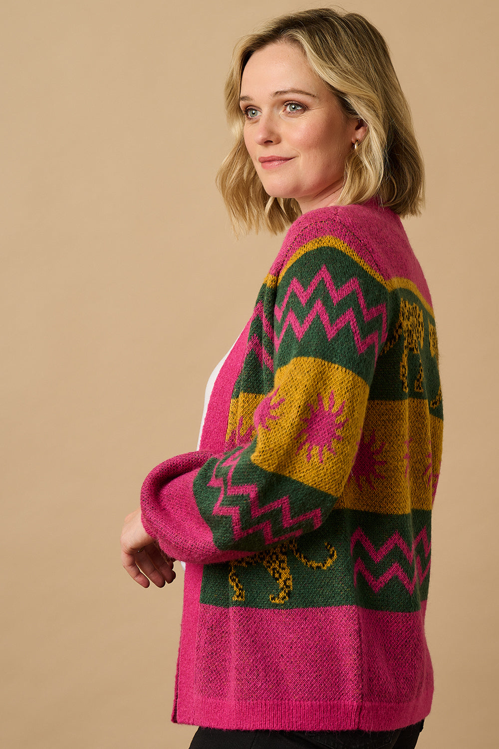 A model wearing a multicoloured cardigan with sun leopard pattern, balloon sleeves, and a relaxed fit.