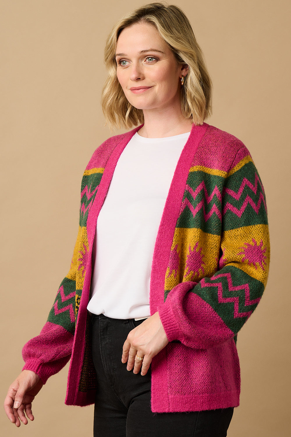 A model wearing a multicoloured cardigan with sun leopard pattern, balloon sleeves, and a relaxed fit.