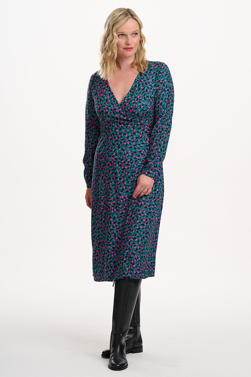 Woman wearing a patterned dress with long sleeves on a white background