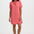 Woman wearing a pink shirt dress on a white background