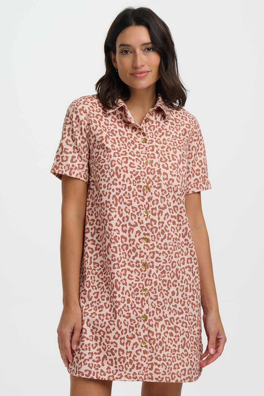 Woman wearing a pink leopard print dress on a white background