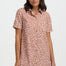 Woman wearing a pink leopard print dress on a white background
