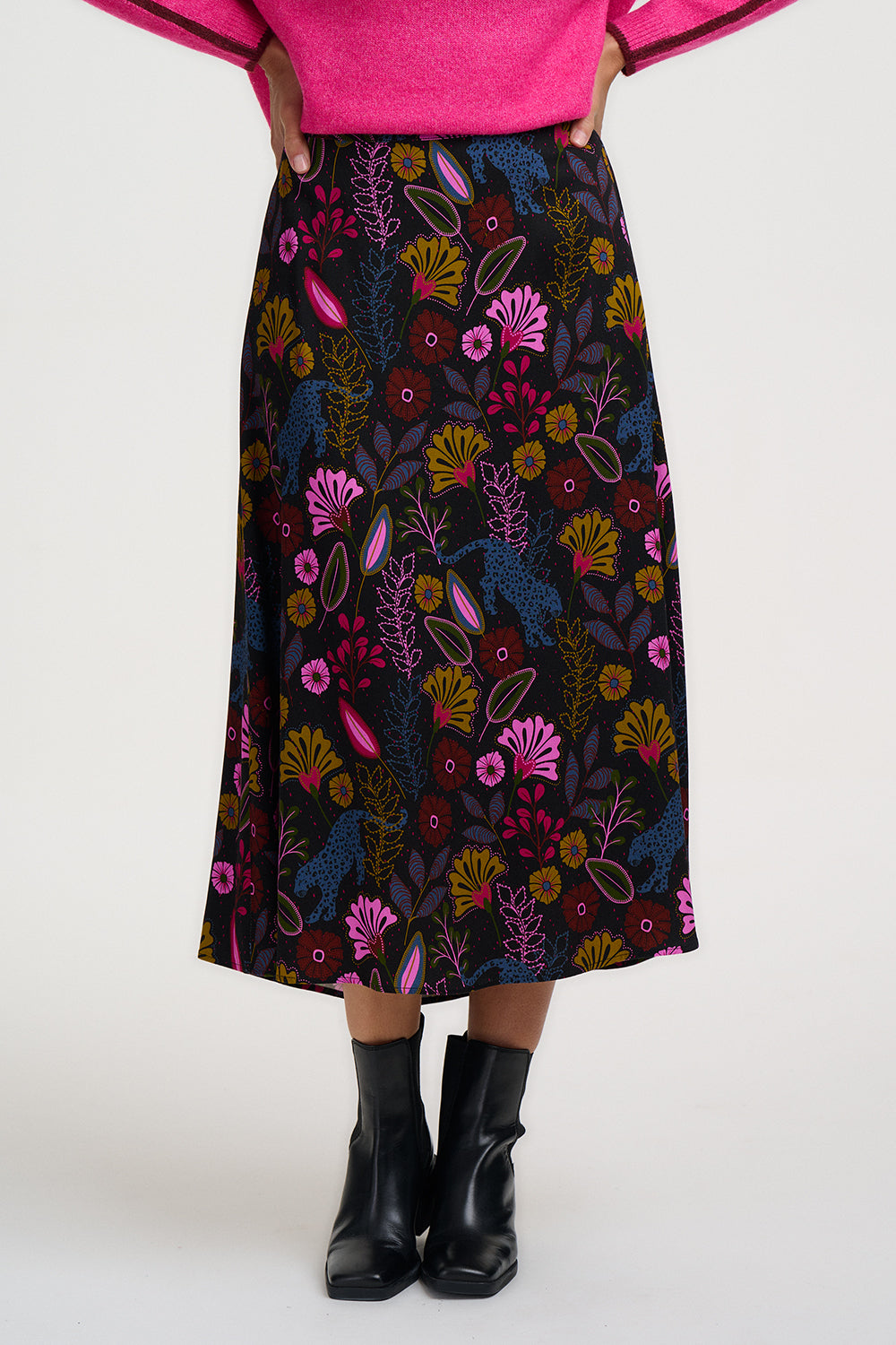 Person wearing a colorful floral skirt on a white background