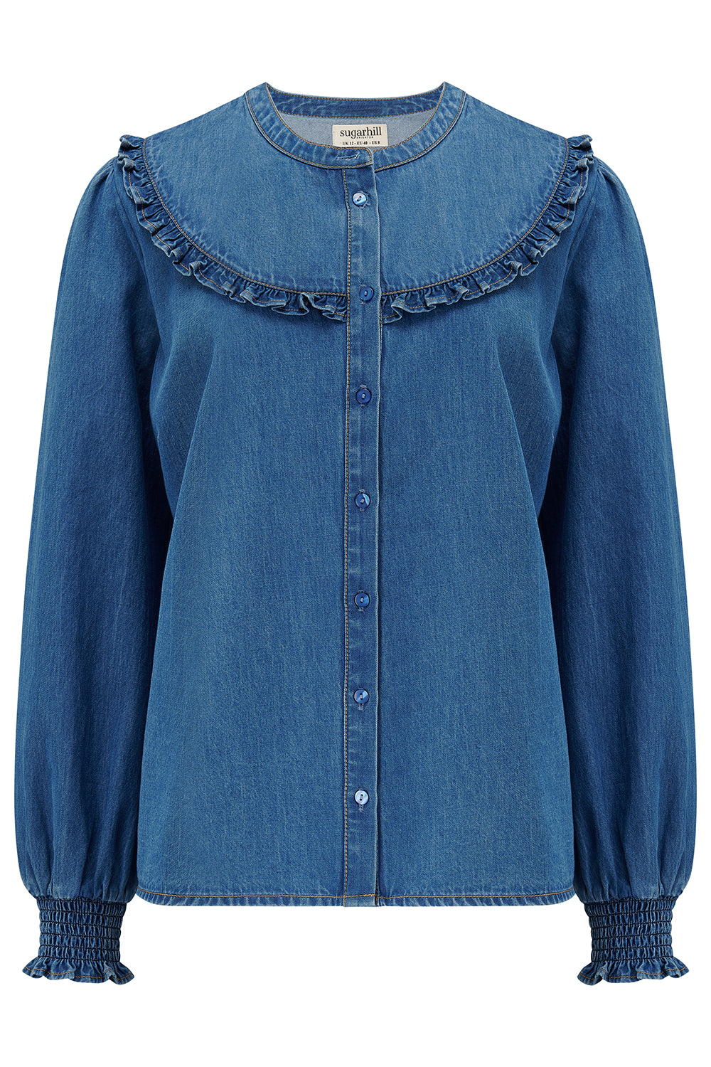 Sugarhill Brighton blue denim blouse with ruffled collar and cuffs on a white background
