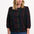 Sugarhill Brighton model wearing a black blouse with a colourful pattern on a white background
