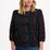 Sugarhill Brighton model wearing a black blouse with a colourful pattern on a white background