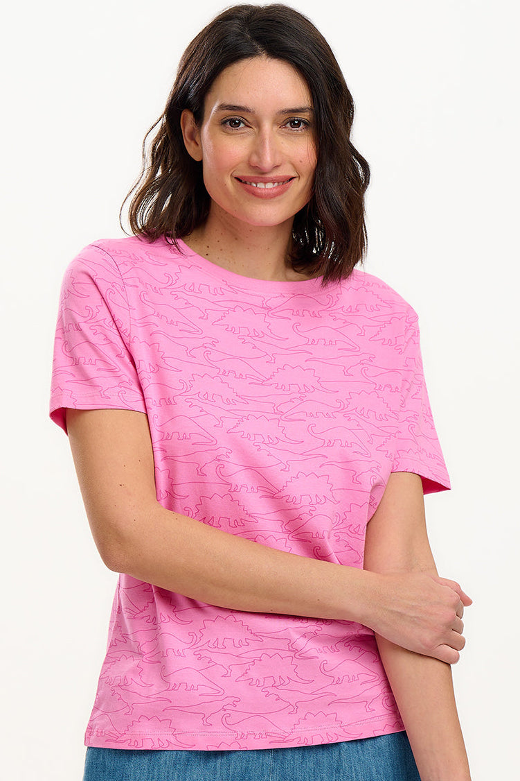 A model wearing a bright pink t-shirt with straight neckline, short sleeves, and a regular fit. The t-shirt has playful pink dinosaur outlines on it.