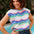 Woman wearing a colorful striped shirt by a poolside